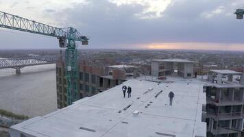 Aerial View. Diverse Team of Specialists Talking On the Skyscraper Formwork Construction Site. Real Estate Project Civil Engineer, and Worker video