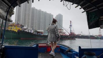 Girl standing on a boat in the bay at the port of Hong Kong video