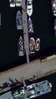 Aerial view of Pier with the ships in the port city. Lofoten archipelago in Norway, vertical footage video