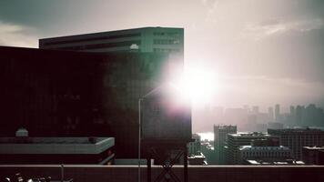 Sunlight reflecting on urban buildings at dusk with a hazy skyline view video