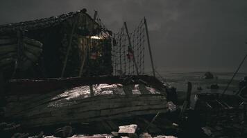 Desolate shoreline with weathered boat and dramatic twilight sky video