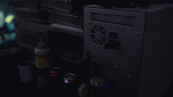 Retro computer setup with tools and containers in a dimly lit workshop video