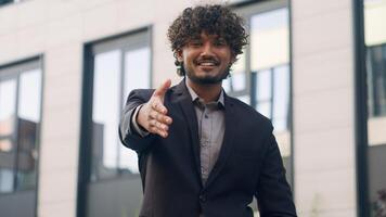Close up Indian business worker man Arabian businessman male entrepreneur employer manager leader HR recruiter extend hand for handshake welcome gesture handshaking inviting formal greeting in city photo