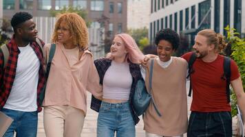Happy smiling multiracial students diverse multiethnic diversity friends walking in city university college campus outdoors studying hugging together talking communicating laughing walk to lesson photo
