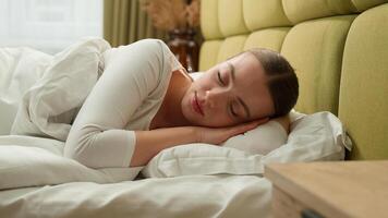 Caucasian relaxed calm peace sleeping woman female sleep napping morning in comfortable cozy bed at home hotel girl asleep lying on soft pillow white linen orthopedic mattress relaxing health care nap photo
