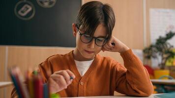 Caucasian guy boy think find idea ponder difficult task writing notes math exercise class lesson school learn write copybook kid schoolboy child pupil thinking studying primary education rise finger photo