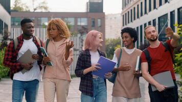 Happy multiracial friends diverse classmates multiethnic students smiling talking speaking laughing talk class break walking in city outdoors university college discuss studying education friendship photo