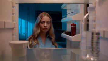 Point of view POV inside refrigerator Caucasian girl hungry woman open fridge at home kitchen look at empty shelves order food products delivery with mobile phone app online service web store shopping photo