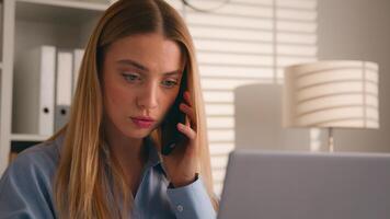 Caucasian girl talk to client on cellphone use laptop discuss deal woman businesswoman consultant agent at home office working with computer make order consultation support customer talking phone call photo