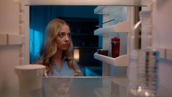 Point of view POV inside refrigerator Caucasian girl hungry woman open fridge at home kitchen look at empty shelves order food products delivery with mobile phone app online service web store shopping photo