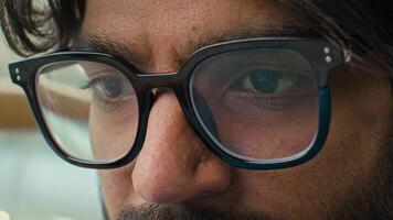 Close up view of male eyes businessman wearing computer glasses eyewear male man in eyeglasses for reducing eye strain good vision looking at laptop screen reading in internet watching working online photo