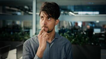 Thoughtful puzzled indian arabian man office manager smart creative concentrated worker businessman think plan ponder new idea brainstorming mind thoughts create project planning business development photo