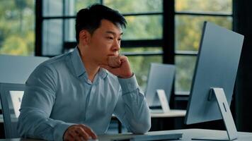 Asian businessman korean man work online at workplace difficult hard job get incorrect error in computer failure business problem. Upset anxious male disappointed about mistake bad internet in office photo