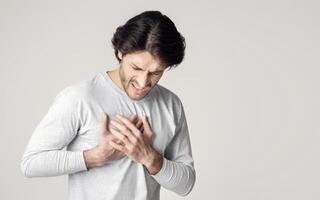 Healthcare concept. Man suffering from chest pain with painful expression photo