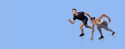 A man and woman are positioned in a starting stance for a sprint. They are both focused and energized, showcasing a collaborative workout session. The simple blue background enhances their movements. photo