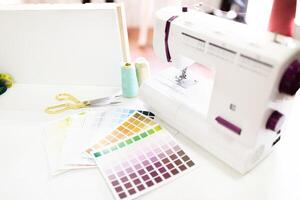 Tools like scissors and a sewing machine are neatly arranged on the table, showcasing creativity. photo
