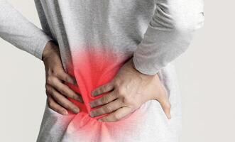 Pain in back and kidneys of man, highlighted in red photo