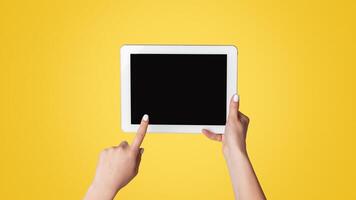 Millennial woman touching empty screen of tablet device on light background, close up. Space for design photo
