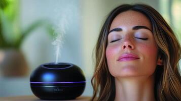 A person relaxes with eyes closed as an essential oil diffuser emits gentle steam in a tranquil environment filled with greenery, inviting a sense of peace and calm. photo