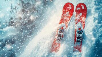 Skiing in fresh powder with vibrant red skis on a snowy mountain landscape during winter photo