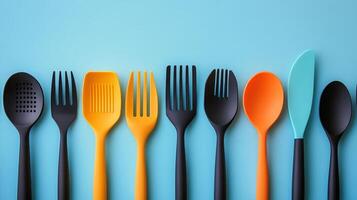 Colorful kitchen utensils arranged neatly on a vibrant surface photo