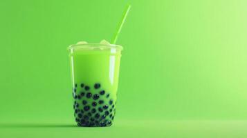 A vibrant green drink filled with large tapioca pearls sits on a bright green background. The cup is clear, showing the refreshing beverage inside, complete with ice and a straw. photo