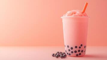 A vibrant cup of bubble tea filled with a pink milk mixture and topped with ice. Dark boba pearls rest at the bottom, complemented by a bright orange straw, all set against a soft pastel backdrop. photo