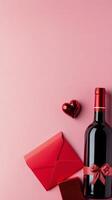 Romantic gift arrangement with red envelopes, wine bottle, and hearts on pink background photo
