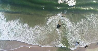 drone side view shot in zenithal view along the shore of a turquoise water beach in summer video