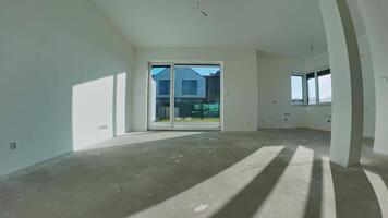 Timelapse of sunlight with shadows on concrete floor through large windows in empty interior of modern room with white walls video