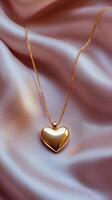 Gold heart necklace resting on soft satin fabric in elegant display photo
