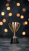 Golden trophy with bokeh lights on a dark background during a celebration event photo