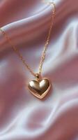Gold heart necklace resting on soft satin fabric in elegant display photo