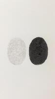 Unique fingerprint designs showcasing contrast between dark and light tones on a textured background photo