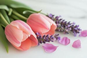 Beautiful arrangement of pink tulips and lavender on a light textured surface photo