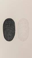 Unique fingerprint designs showcasing contrast between dark and light tones on a textured background photo