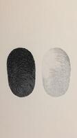 Unique fingerprint designs showcasing contrast between dark and light tones on a textured background photo