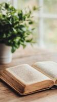 Old open book resting on a wooden surface with soft lighting and natural textures photo