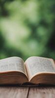Old open book resting on a wooden surface with soft lighting and natural textures photo