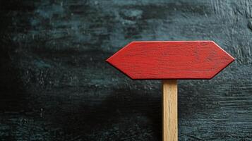 Empty red wooden sign on a dark textured surface ready for messages or directions photo