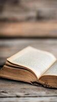 Old open book resting on a wooden surface with soft lighting and natural textures photo