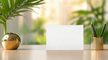 Fresh indoor plants on a modern table with a blank card for personalization on a sunny day photo