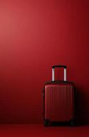 Red suitcase against a solid red background in a minimalist setting photo