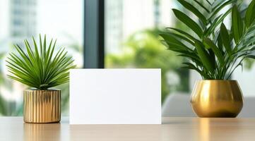 Fresh indoor plants on a modern table with a blank card for personalization on a sunny day photo