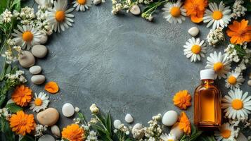 Flowers and essential oils on a gray background photo