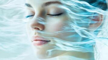 A woman with her eyes closed and her face covered in water photo