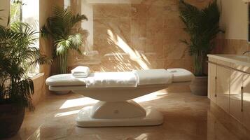 A white massage table in a bathroom with a window photo
