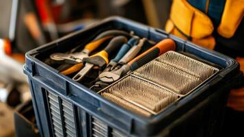 A man holding a tool box with tools in it photo