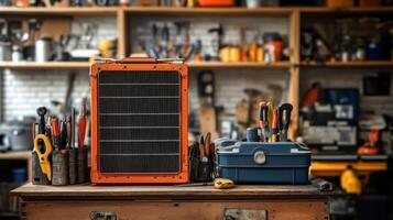 An orange solar panel sits on a table next to a toolbox photo