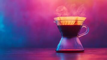 Coffee brewing in a glass coffee pot on a table photo